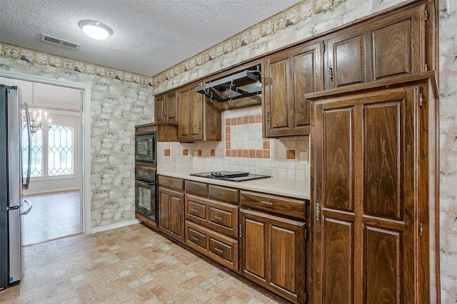 6809 River Bend Rd, Fort Worth, TX 76132 - kitchen with an inviting chandelier, baseboards, light countertops, a textured ceiling, and black appliances
