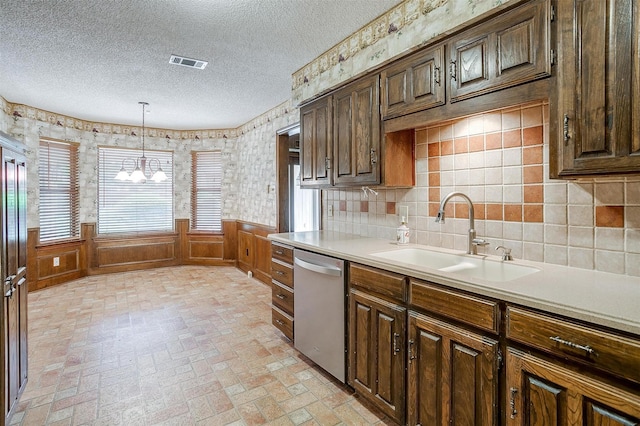 6809 River Bend Rd, Fort Worth, TX 76132 - kitchen with a notable chandelier, a sink, a textured ceiling, stainless steel dishwasher, and visible vents