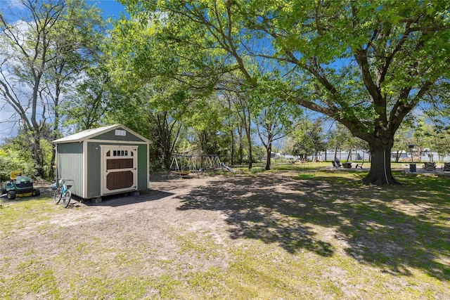 10908 County Road 442, Princeton, TX 75407 - view of yard with an outdoor structure, a playground, and a storage unit