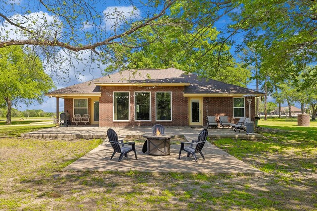 10908 County Road 442, Princeton, TX 75407 - back of property featuring a patio area, brick siding, a yard, and an outdoor fire pit