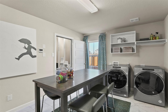 washroom with laundry area, a textured ceiling, visible vents, marble finish floor, and washing machine and dryer
