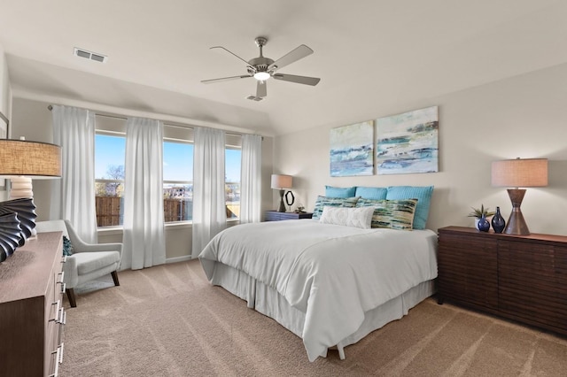 bedroom with light carpet, visible vents, and ceiling fan