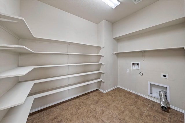 washroom featuring laundry area, hookup for a washing machine, electric dryer hookup, gas dryer hookup, and baseboards
