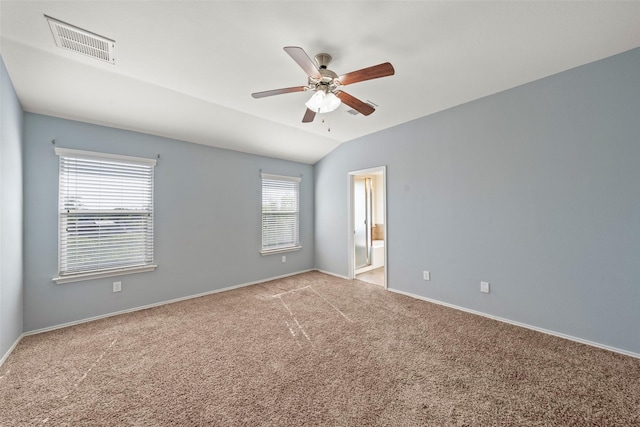 unfurnished room with carpet, visible vents, baseboards, and a ceiling fan