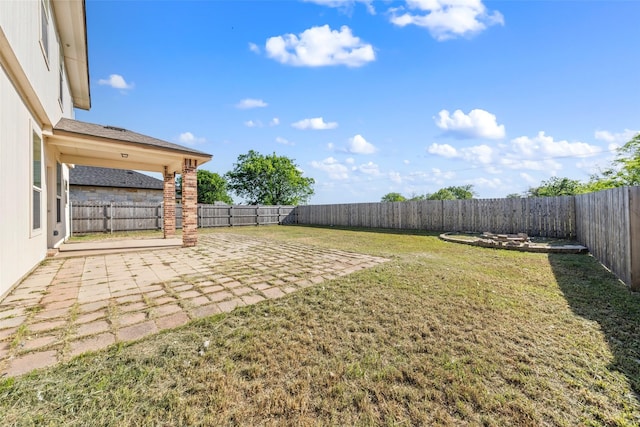 view of yard with a fenced backyard and a patio