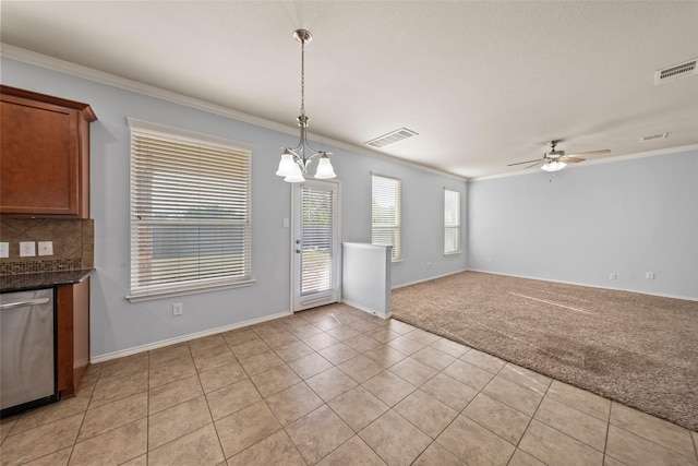 unfurnished dining area featuring ceiling fan with notable chandelier, light tile patterned floors, ornamental molding, and visible vents