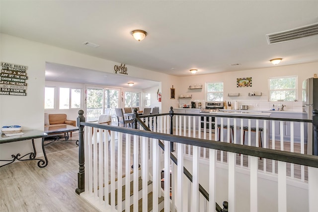 2520 Long Creek Ct, Granbury, TX 76049 - hall with an upstairs landing, visible vents, light wood-type flooring, and a sink
