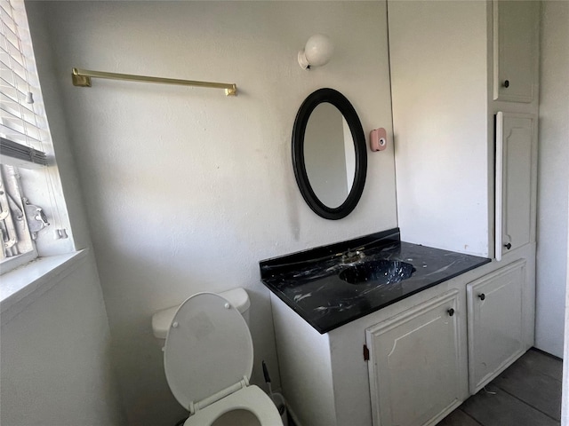bathroom with tile patterned flooring, toilet, and vanity