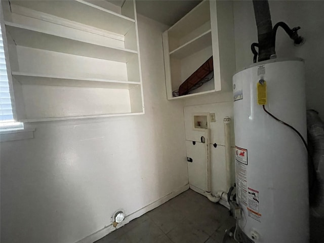 clothes washing area with water heater, hookup for a washing machine, and laundry area