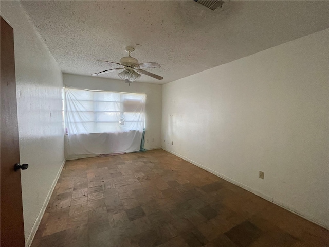unfurnished room featuring ceiling fan, a textured ceiling, visible vents, tile patterned floors, and baseboards