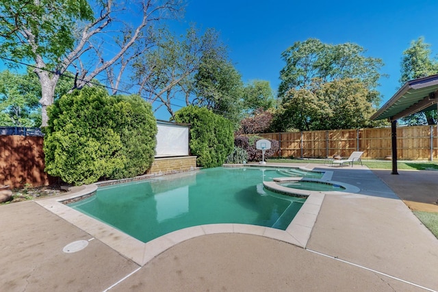 view of pool featuring a pool with connected hot tub, a patio, and fence
