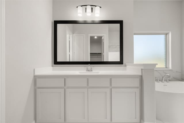 bathroom featuring a freestanding tub and vanity