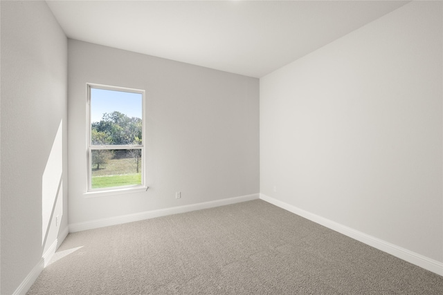 empty room with baseboards and carpet