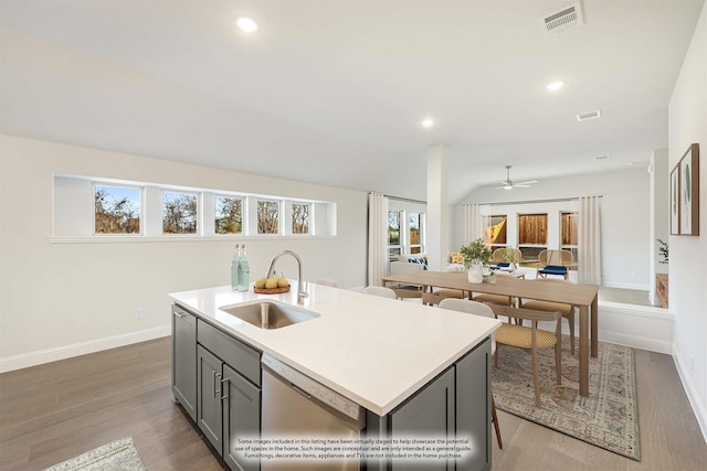 kitchen with visible vents, recessed lighting, wood finished floors, dishwasher, and a sink