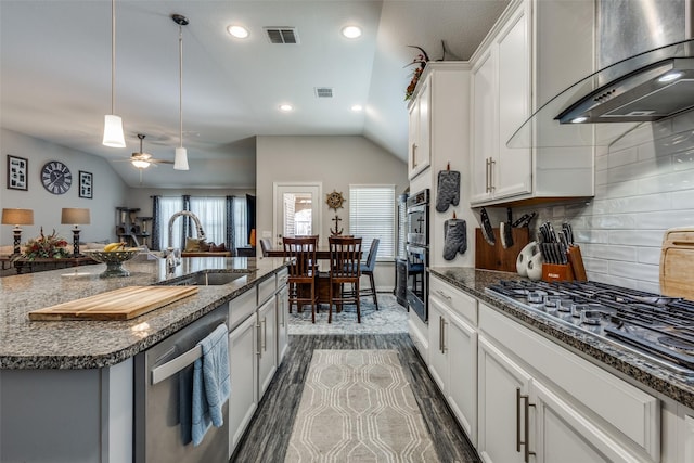 kitchen with visible vents, wall chimney range hood, recessed lighting, a sink, and stainless steel appliances