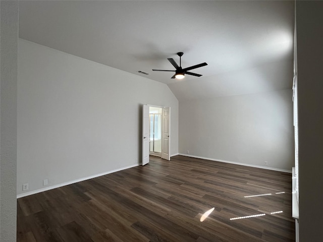 empty room featuring visible vents, baseboards, ceiling fan, dark wood-style floors, and vaulted ceiling