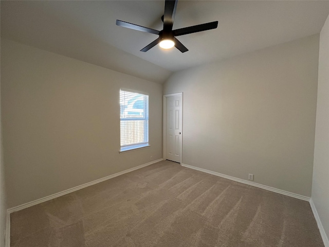 carpeted spare room with baseboards, a ceiling fan, and lofted ceiling