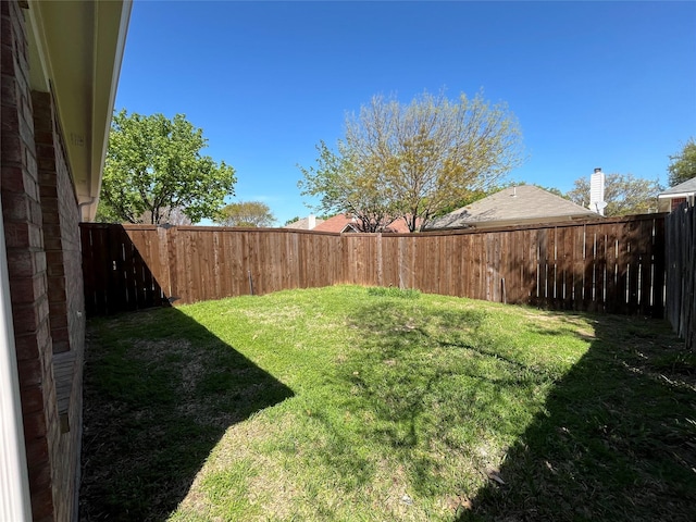 view of yard with a fenced backyard