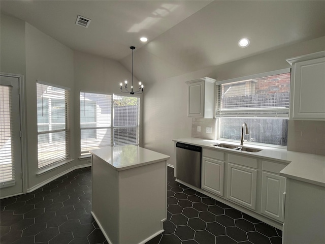 kitchen featuring visible vents, a healthy amount of sunlight, dishwasher, a sink, and lofted ceiling