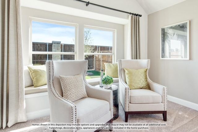 sitting room featuring carpet flooring, baseboards, and lofted ceiling