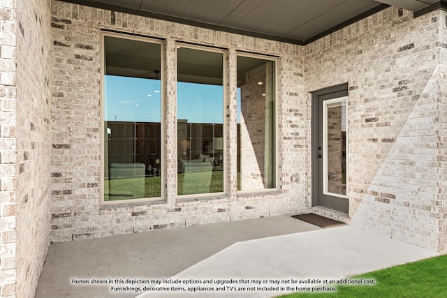 property entrance with brick siding