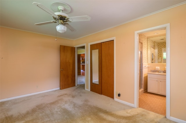 unfurnished bedroom featuring a closet, crown molding, and carpet floors
