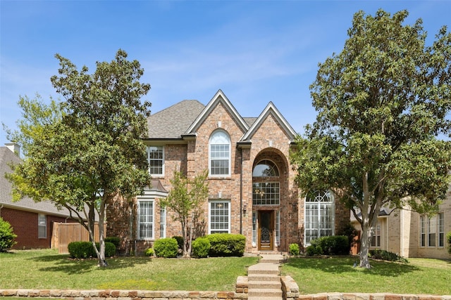 2605 Owl Creek Dr, Plano, TX 75025 - view of front of property with a front yard, brick siding, and fence