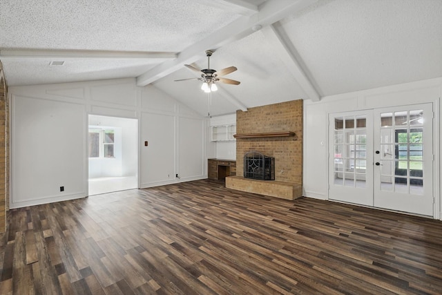 unfurnished living room featuring a ceiling fan, dark wood-type flooring, and a textured ceiling