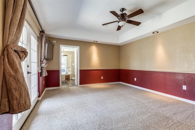 carpeted empty room featuring baseboards, a ceiling fan, french doors, and lofted ceiling