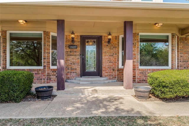 doorway to property with brick siding
