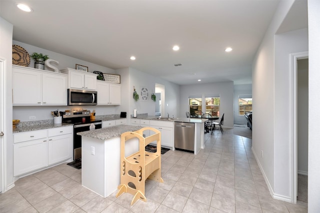 9449 Firedog Dr, Fort Worth, TX 76131 - kitchen with appliances with stainless steel finishes, a peninsula, a sink, recessed lighting, and white cabinets