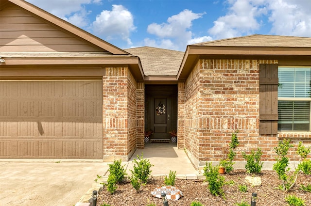 9449 Firedog Dr, Fort Worth, TX 76131 - doorway to property featuring brick siding, driveway, a shingled roof, and a garage