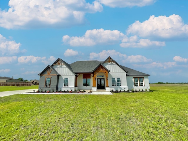 modern farmhouse featuring board and batten siding, a front lawn, and french doors