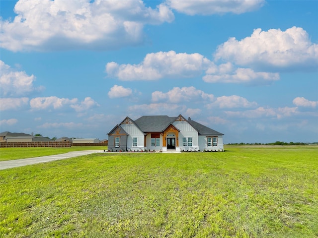 modern inspired farmhouse featuring board and batten siding, driveway, and a front yard
