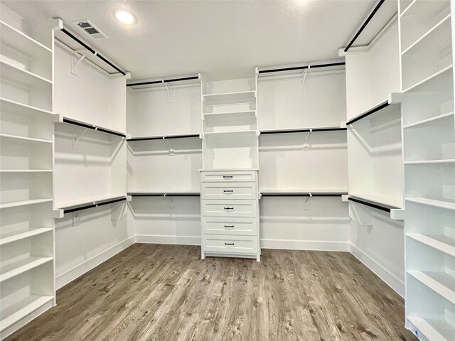 walk in closet with light wood-style floors and visible vents