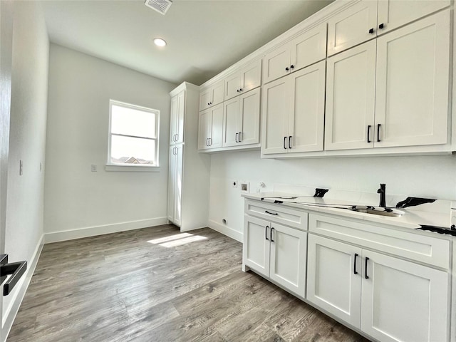 laundry room featuring hookup for a washing machine, hookup for an electric dryer, cabinet space, baseboards, and visible vents