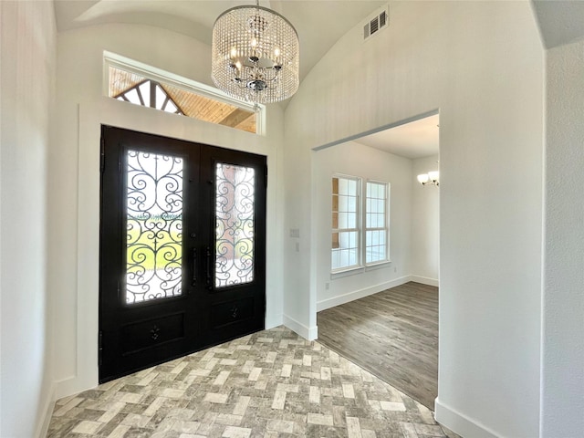 entryway featuring high vaulted ceiling, an inviting chandelier, french doors, baseboards, and visible vents