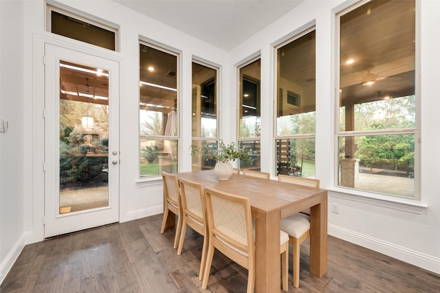 sunroom with a healthy amount of sunlight, baseboards, and wood finished floors