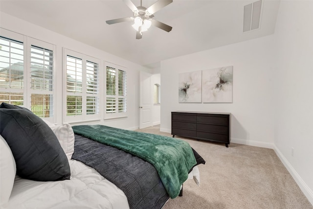 bedroom with a ceiling fan, baseboards, visible vents, and carpet