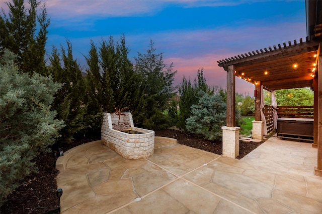 patio terrace at dusk with a hot tub