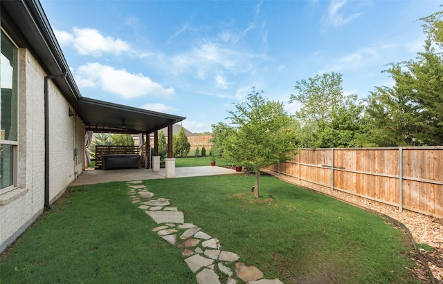 view of yard featuring a patio, a fenced backyard, and a ceiling fan