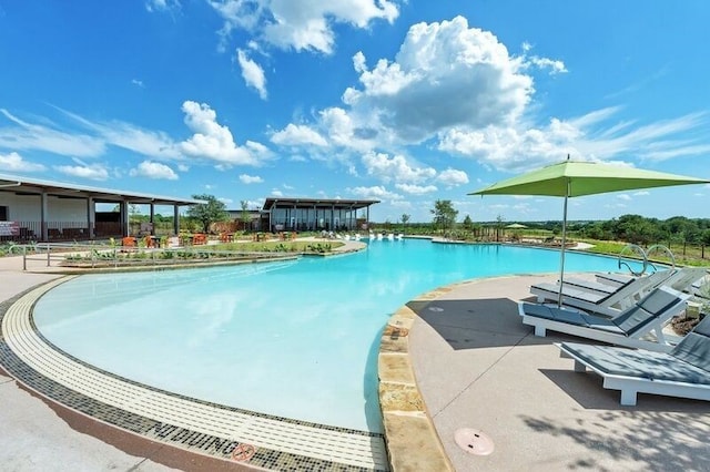 community pool with a patio area