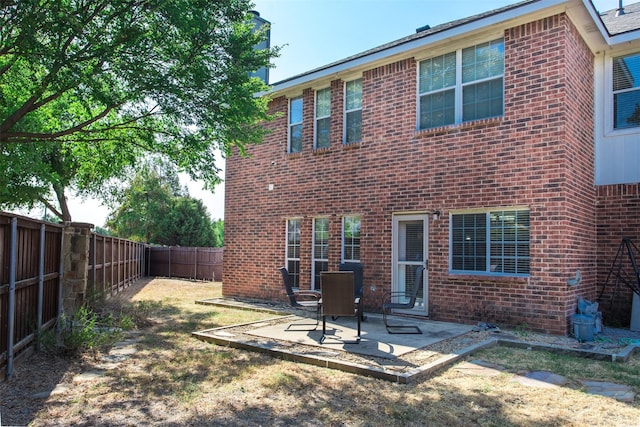 1314 Kingsley Ct, Allen, TX 75013 - back of property with a fenced backyard, a patio area, and brick siding