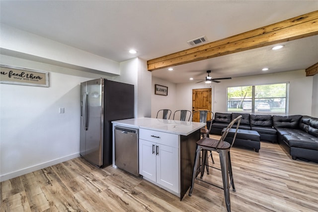 3452 Antilles Dr, Mesquite, TX 75150 - kitchen featuring open floor plan, stainless steel appliances, recessed lighting, white cabinets, and light wood finished floors