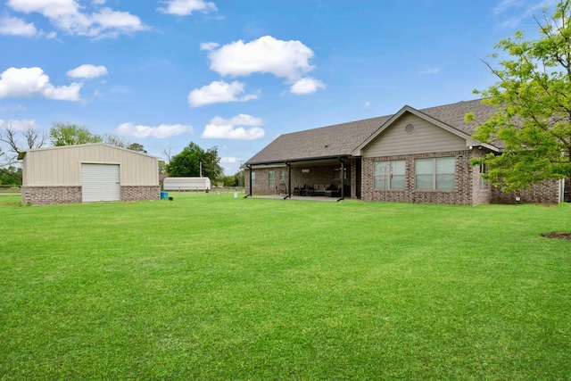 back of house with a garage, brick siding, and a lawn