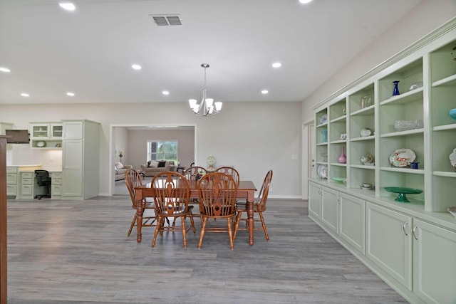 dining area with recessed lighting, an inviting chandelier, light wood-style floors, baseboards, and visible vents