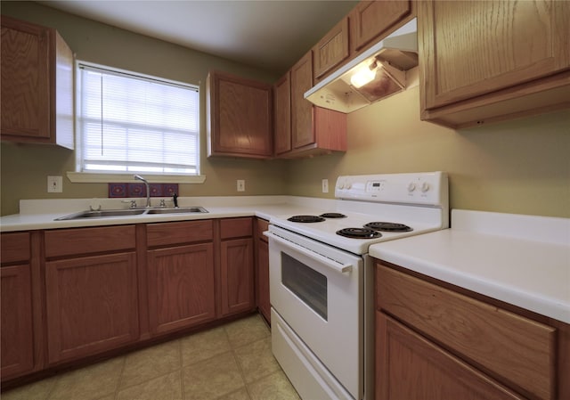 kitchen with light countertops, under cabinet range hood, brown cabinets, white electric range oven, and a sink