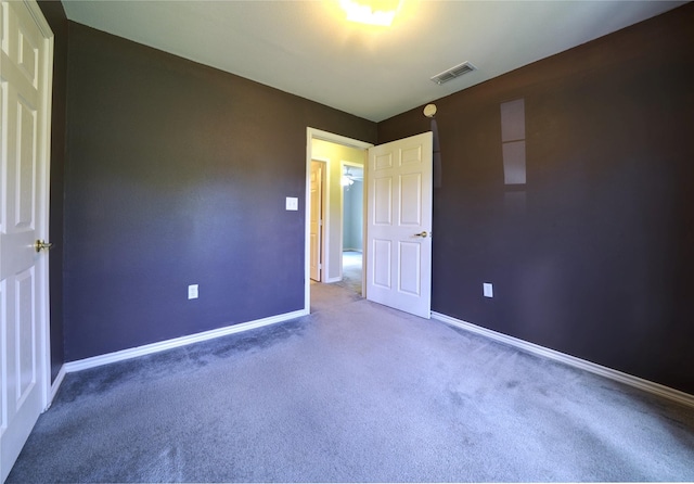 unfurnished bedroom featuring visible vents, baseboards, and carpet floors
