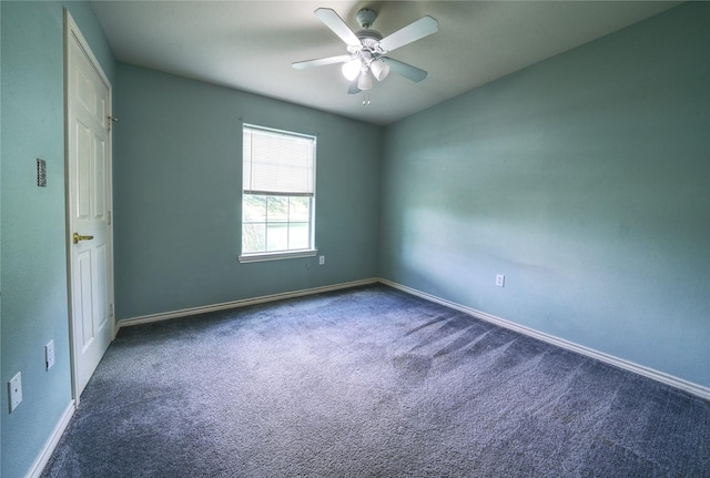 carpeted spare room with baseboards and ceiling fan