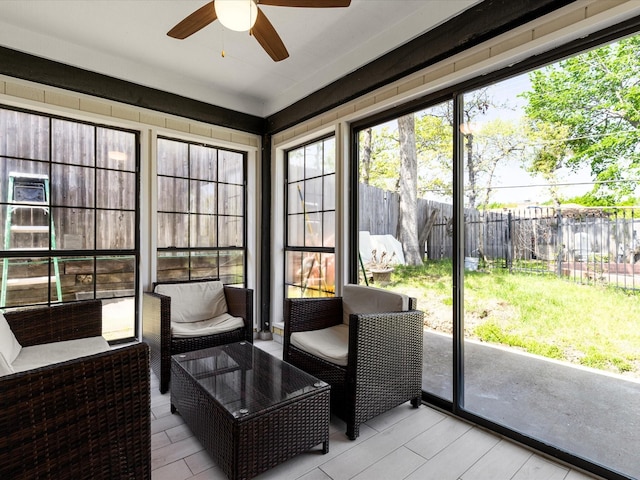 sunroom with ceiling fan and a wealth of natural light